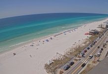 Scenic aerial shot of Miramar Beach, Florida, featuring sandy shores and ocean waves, as seen from the Empress condominium webcam.